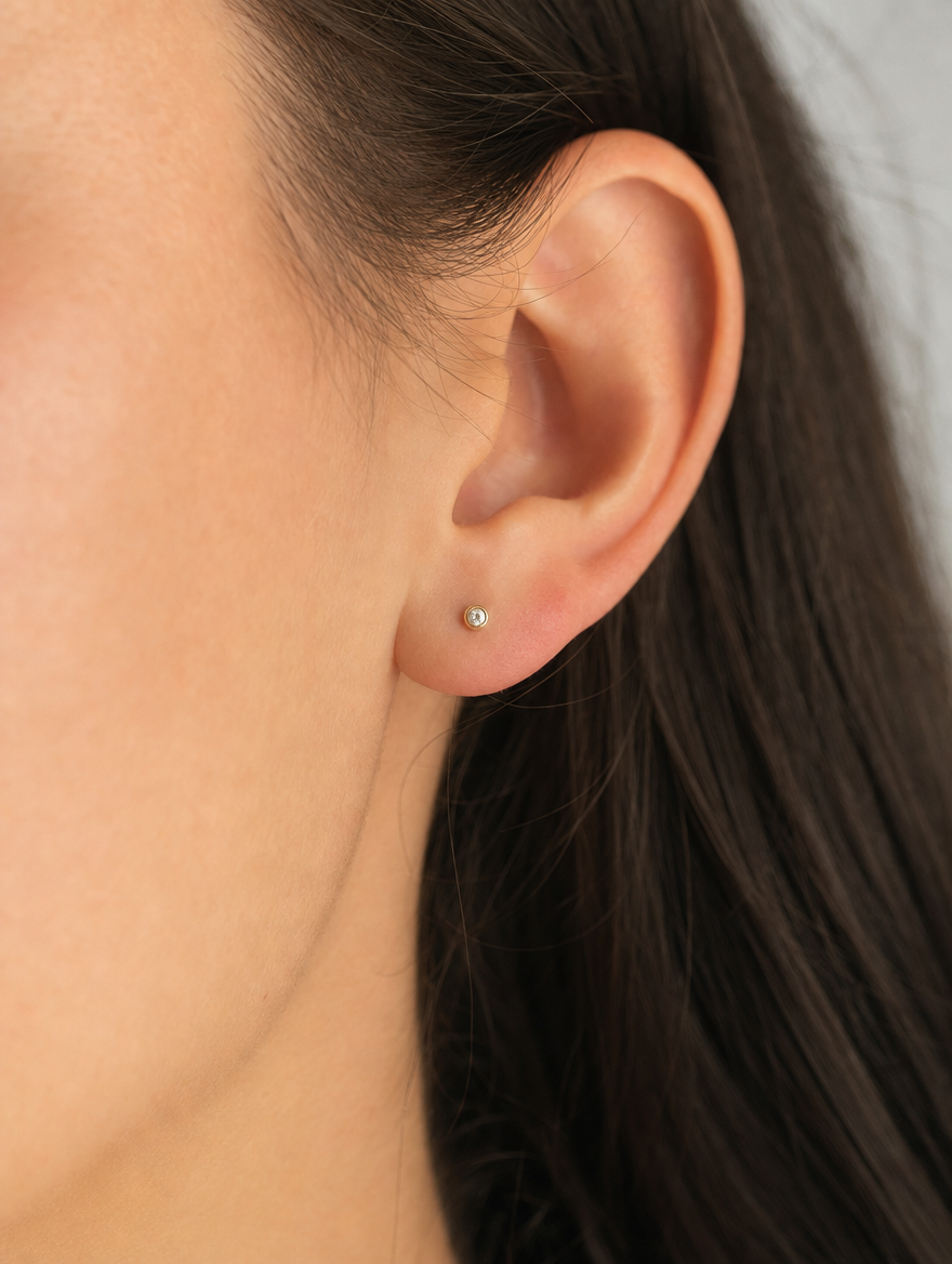 Broquel Bisel Zirconia Blanca 2.5 mm Oro 10K puesto — modelo