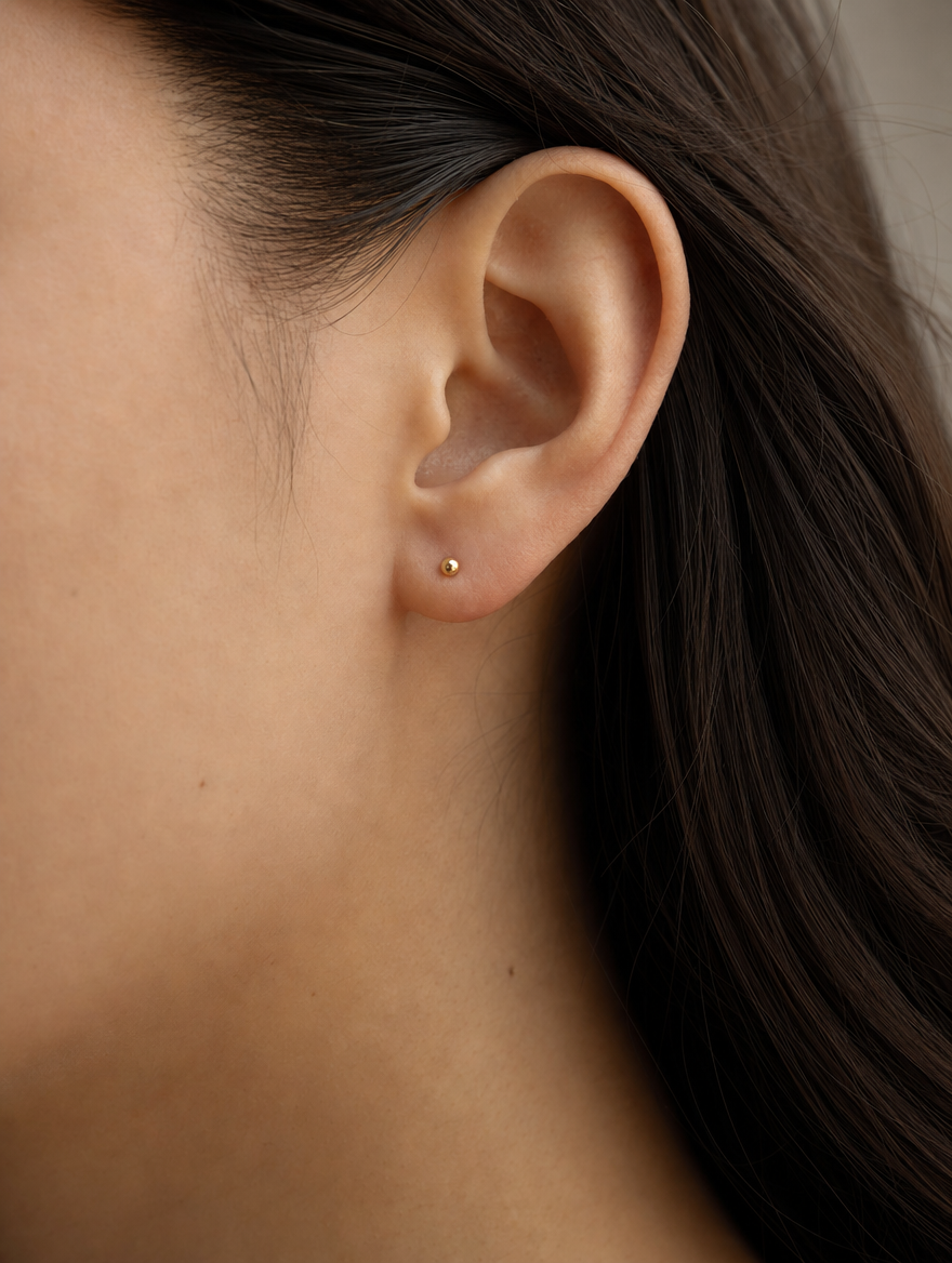 Broquel Dormilona 6 mm Oro 10K puesto — modelo