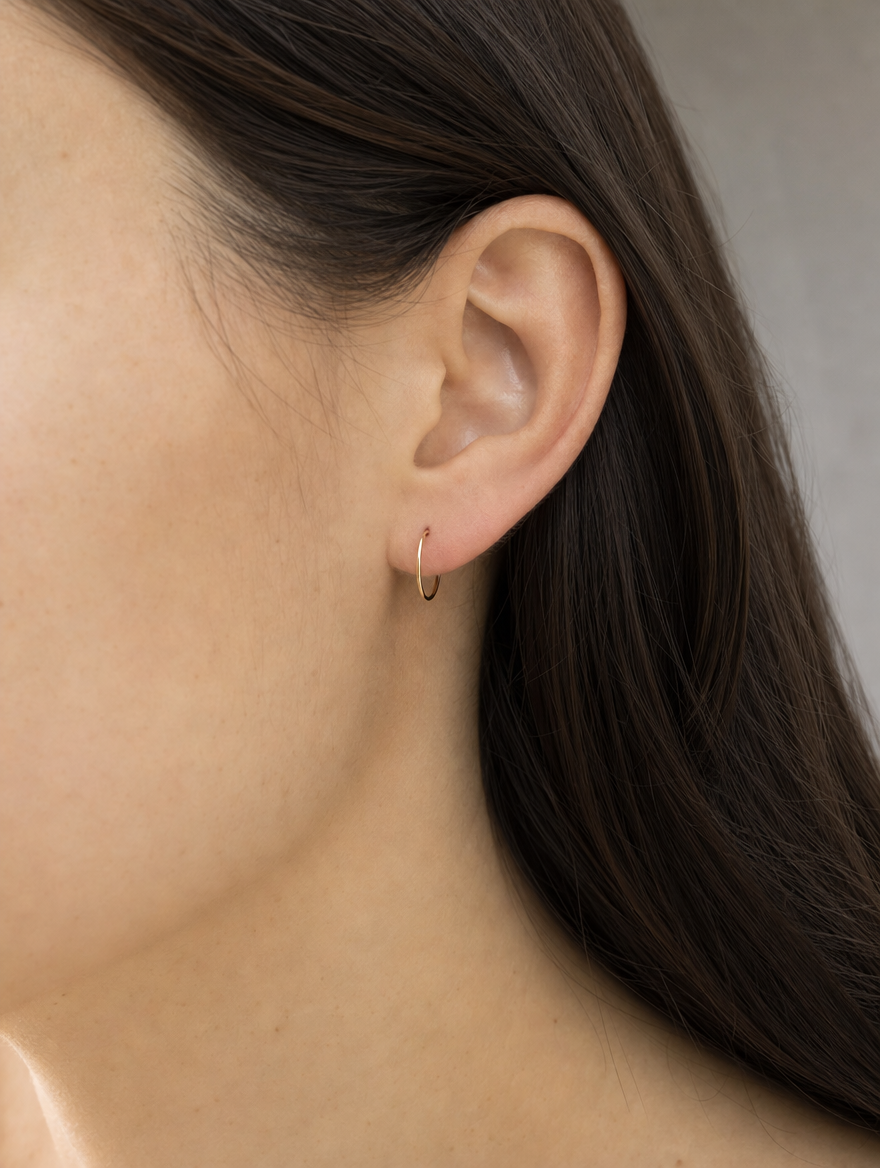 Arracada Lisa 9 mm Oro 10K puesto — modelo
